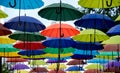 many colorful umbrellas fly and hover on the city street Royalty Free Stock Photo