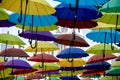 many colorful umbrellas fly and hover on the city street Royalty Free Stock Photo