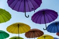 many colorful umbrellas fly and hover on the city street Royalty Free Stock Photo