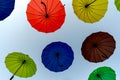 many colorful umbrellas fly and hover on the city street Royalty Free Stock Photo