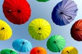 many colorful umbrellas fly and hover on the city street Royalty Free Stock Photo