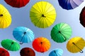 many colorful umbrellas fly and hover on the city street Royalty Free Stock Photo