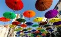 many colorful umbrellas fly and hover on the city street Royalty Free Stock Photo