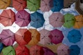 Many colorful umbrellas hanging in the sky as background in street decoration