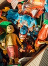 Many colorful wooden toys with figure of Krishna and common people in retro traditional style of India, in indian store