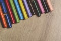 Many colourful used crayon in a row