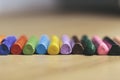 Many colourful used crayon in a row