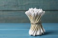 Many cotton buds on light blue wooden table, space for text Royalty Free Stock Photo