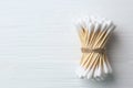 Many cotton buds on white wooden table, top view. Space for text Royalty Free Stock Photo