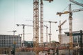 Many cranes and construction workers on construction site Royalty Free Stock Photo