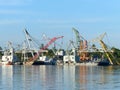 Many cranes are waiting for cargo in harbour