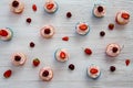 Many cupcakes with white cream and strawberries on a wooden table Royalty Free Stock Photo