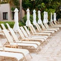 Many deck chairs standing on the hotel territory.