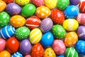 Many decorated Easter eggs as background, top view.