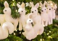 Many deer row of white decorations decoration on a background of green fir and squirrel in the foreground