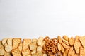 Many delicious crackers on white wooden table, flat lay. Space for text Royalty Free Stock Photo