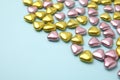 Many delicious heart shaped candies on light blue background. Space for text Royalty Free Stock Photo