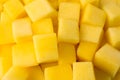 Many delicious mango cubes as background