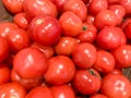 Many delicious red tomatoes in supermarket, whole fresh organic vegetables for sale at a farm market Royalty Free Stock Photo
