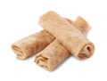 Many delicious rolled crepes on white background