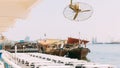 Many Dhow, sailboat, sailing vessel boat is moored to the city pier, jetty in sunny summer day. Urban city background