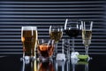 Many different alcoholic drinks on table against dark background Royalty Free Stock Photo