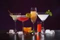 Many different alcoholic drinks on table against dark background Royalty Free Stock Photo