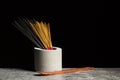 Many different aromatic incense sticks and wooden stand for them. Copy space Royalty Free Stock Photo