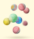 Many different bath bombs falling on beige background Royalty Free Stock Photo