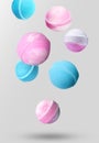 Many different bath bombs falling on light grey background Royalty Free Stock Photo