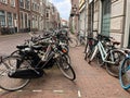 Many different bicycles parked near building on city street Royalty Free Stock Photo