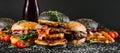 Many different burgers with ingredients on a black background Royalty Free Stock Photo