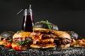 Many different burgers with ingredients on a black background Royalty Free Stock Photo