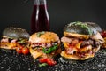 Many different burgers with ingredients on a black background Royalty Free Stock Photo