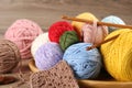 Many different clews of colorful knitting threads and crochet hooks on wooden table Royalty Free Stock Photo