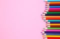 Many different colored pencils on pink background Royalty Free Stock Photo