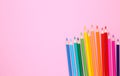 Many different colored pencils on pink background Royalty Free Stock Photo