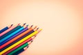 Many different colored pencils on pink background Royalty Free Stock Photo