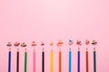 Many different colored pencils on pink background Royalty Free Stock Photo