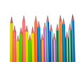 Many different colored wood pencil crayons scattered in a line on a white paper Royalty Free Stock Photo