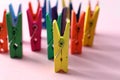 Many different colorful clothes pins on pink background. Diversity concept Royalty Free Stock Photo