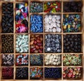 Many different, colorful glass beads, sorted in a wooden box. Royalty Free Stock Photo