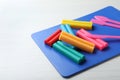 Many different colorful plasticine pieces with tools on white wooden table Royalty Free Stock Photo