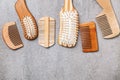 Many different combs and hairbrushes on grey background, flat lay