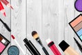 Many different cosmetics over white wooden background