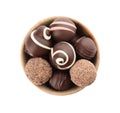 Many different delicious chocolate truffles in bowl on white background, top view Royalty Free Stock Photo