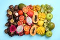 Many different delicious exotic fruits on light blue background, flat lay Royalty Free Stock Photo