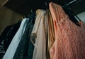 Many different dresses in wardrobe, clothes in ladys dressing ro