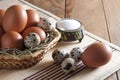 Many different eggs in basket on wooden table. Royalty Free Stock Photo