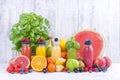 Many different fruits and berries and juices in plastic bottles. Watermelon, banana, applcsin, blueberries, strawberries, basil on Royalty Free Stock Photo